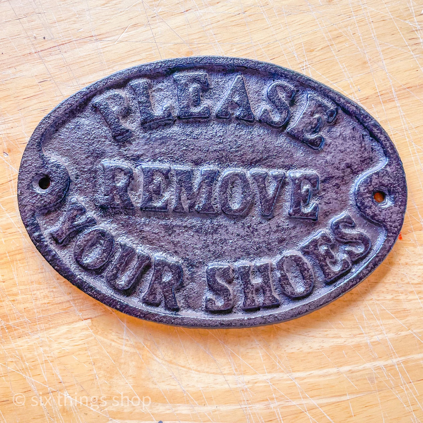 Please remove shoes cast iron sign