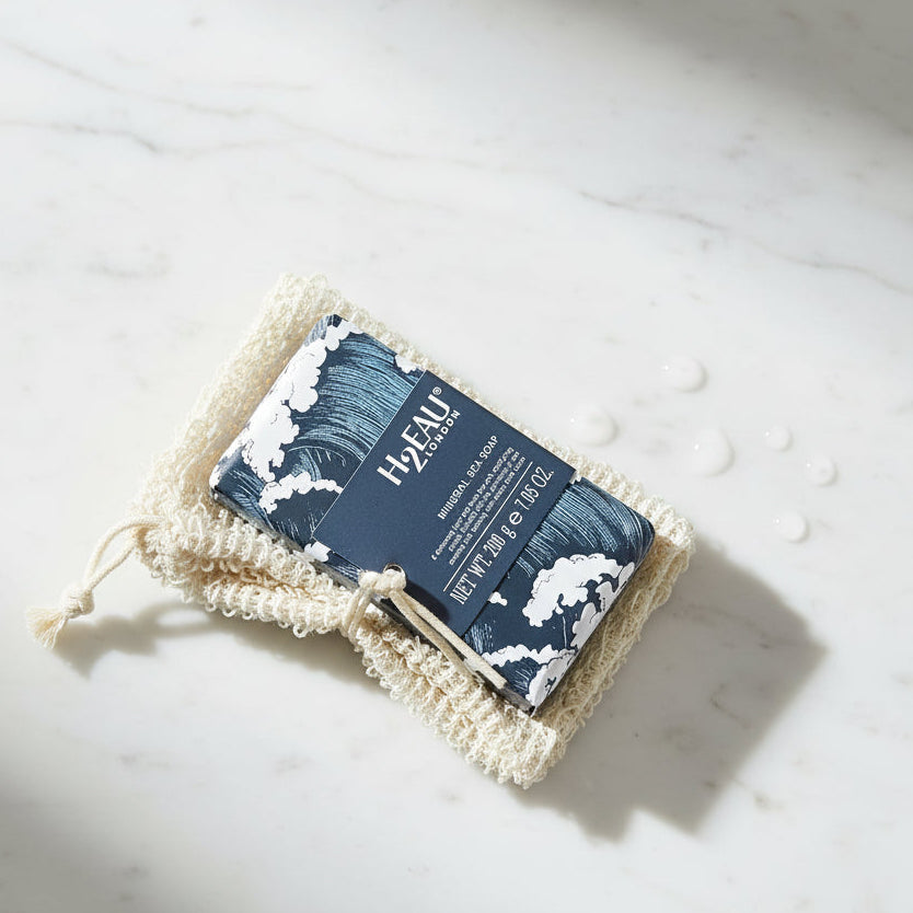 Bar of soap with decorative packaging and H2EAU branding on a white background