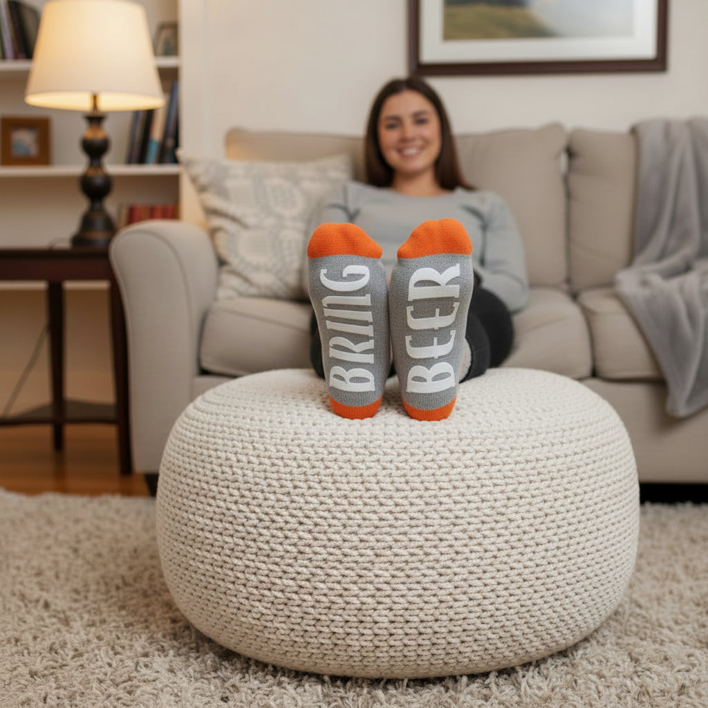 Gray socks with 'BRING BEER' text and orange tips worn by a person.