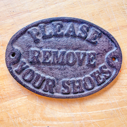 Please remove shoes cast iron sign