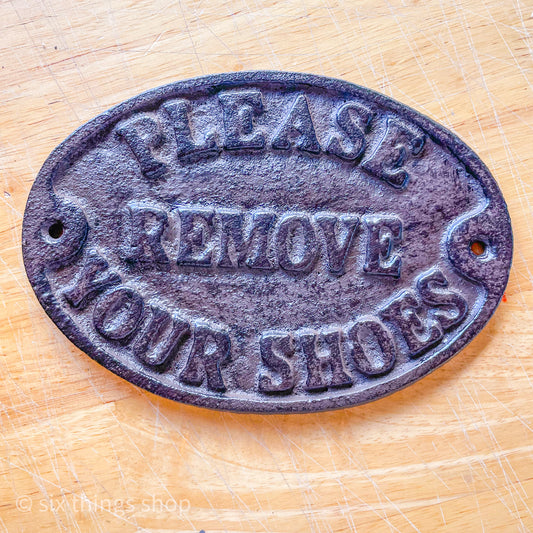 Please remove shoes cast iron sign