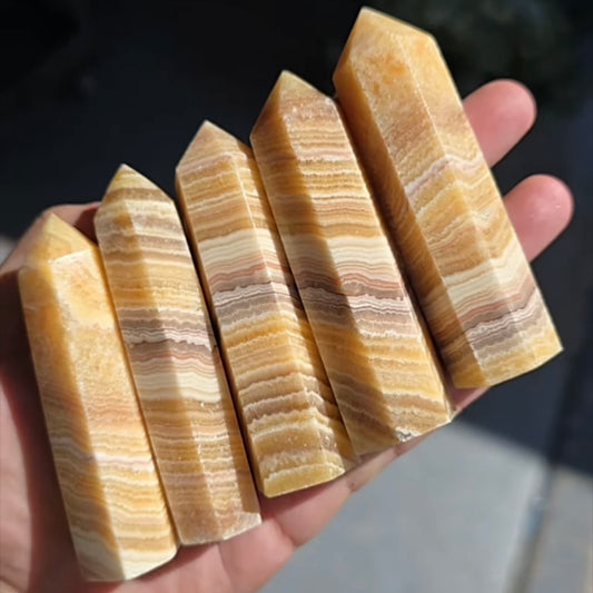 Banded orange calcite crystal point tower