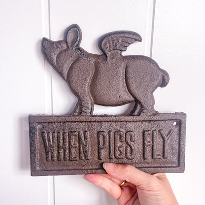 When pigs fly cast iron sign