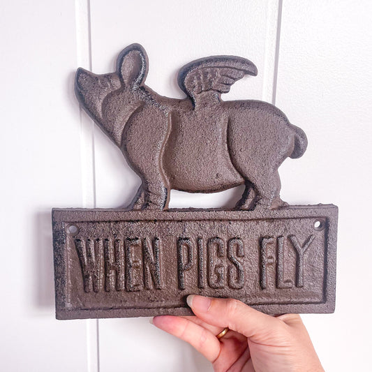 When pigs fly cast iron sign