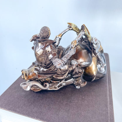 Skeleton on a motorbike skull statue
