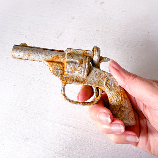 Vintage cast iron pistol / cap gun statue