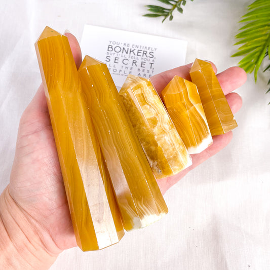 Orange honey calcite crystal tower
